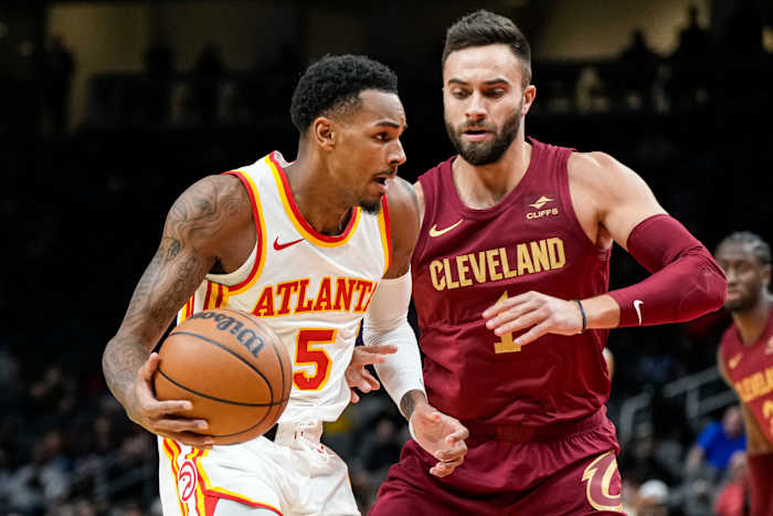 Oct 10, 2023; Atlanta, Georgia, USA; Atlanta Hawks guard Dejounte Murray (5) dribbles against Cleveland Cavaliers guard Max Strus (1) during the first half at State Farm Arena.
